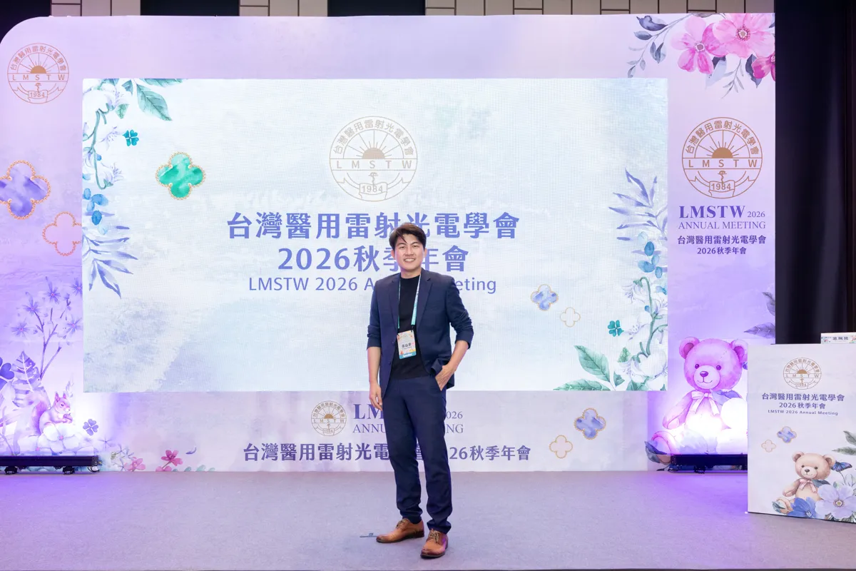 張益豪醫師站在台灣醫用雷射光電學會 2026 秋季年會主背板前