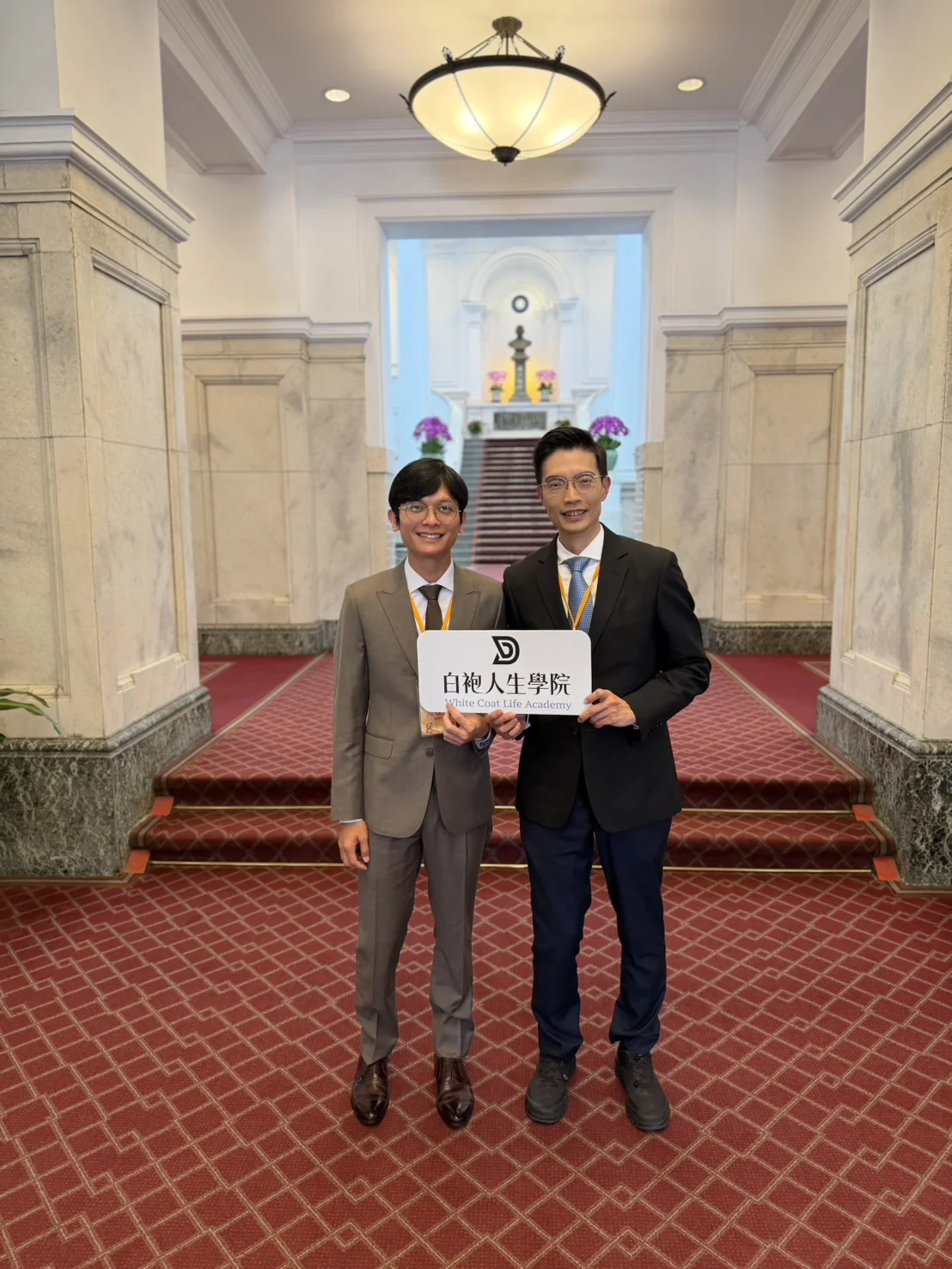 曹皓崴醫師與張益豪醫師於總統府共同持白袍人生學院手牌合影