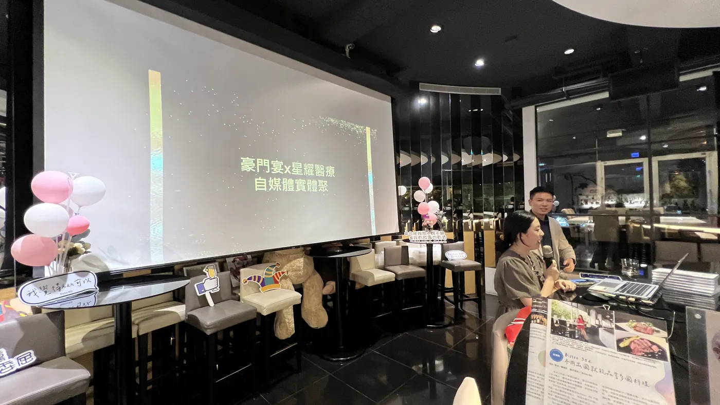 投影幕顯示「豪門宴x星耀醫療 自媒體實體聚」，旁邊有粉白色氣球