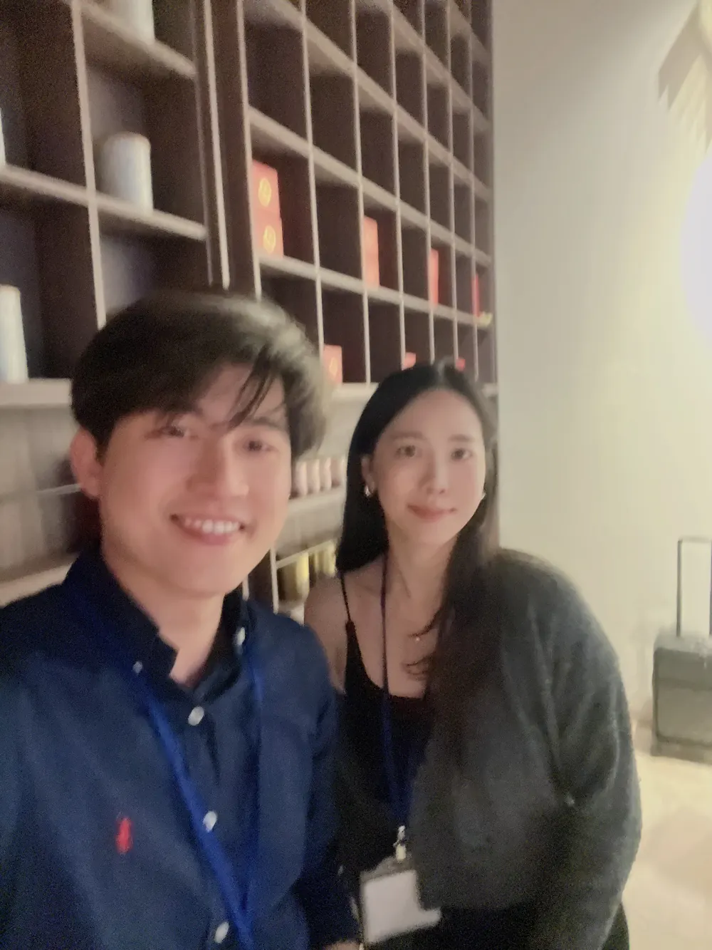 張益豪醫師與一位女醫師在茶廳的木櫃架前自拍