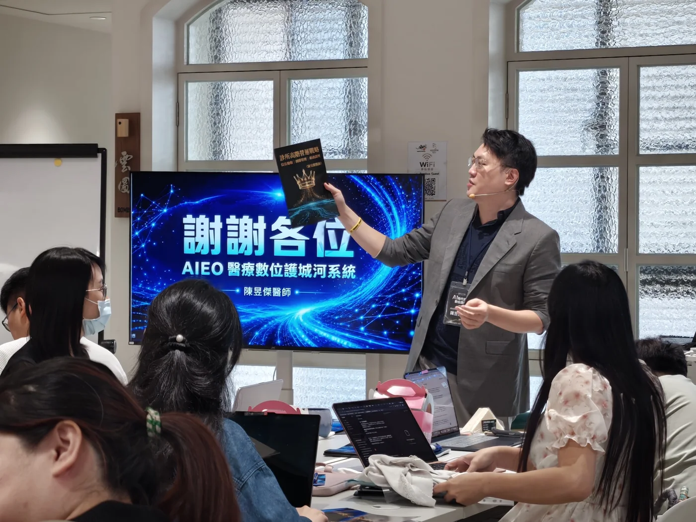 陳昱傑醫師站在「謝謝各位」結尾投影片前，向台下學員致意